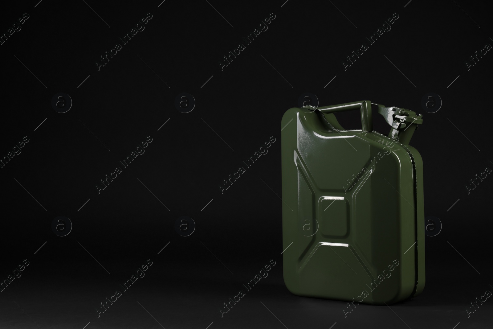 Photo of New khaki metal canister on black background. Space for text