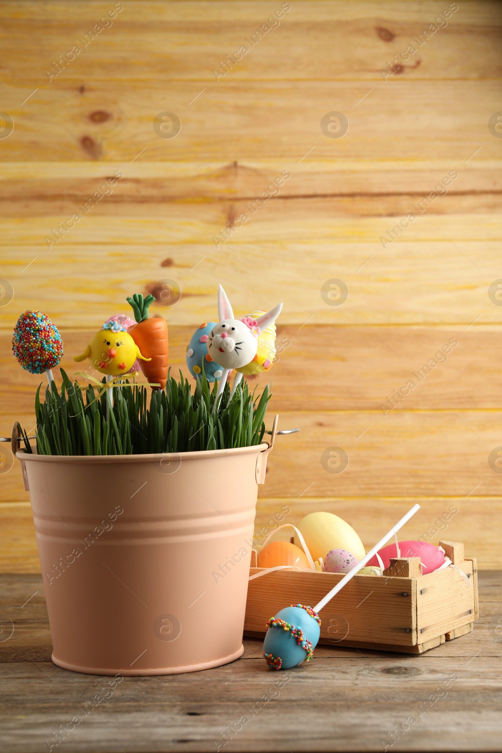 Photo of Delicious sweet cake pops on wooden table. Easter holiday