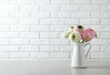 Vase with beautiful ranunculus flowers on table