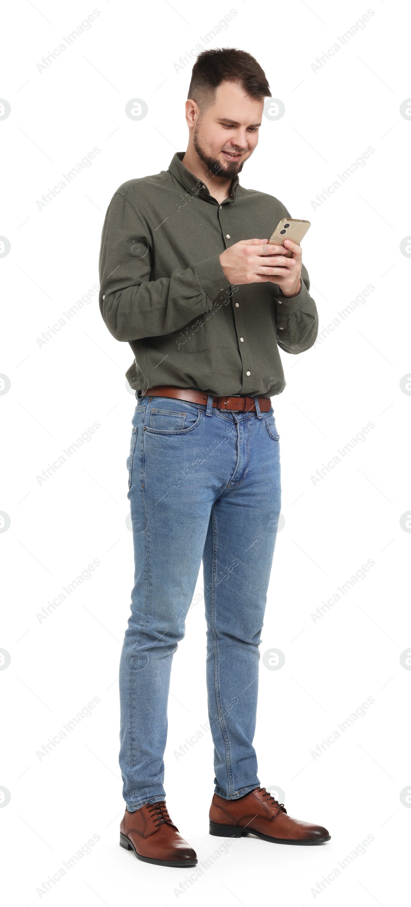 Photo of Man in shirt and jeans using mobile phone on white background