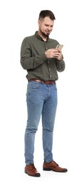 Man in shirt and jeans using mobile phone on white background