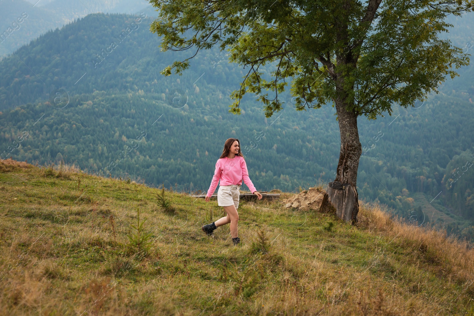 Photo of Young woman enjoying her time in mountains