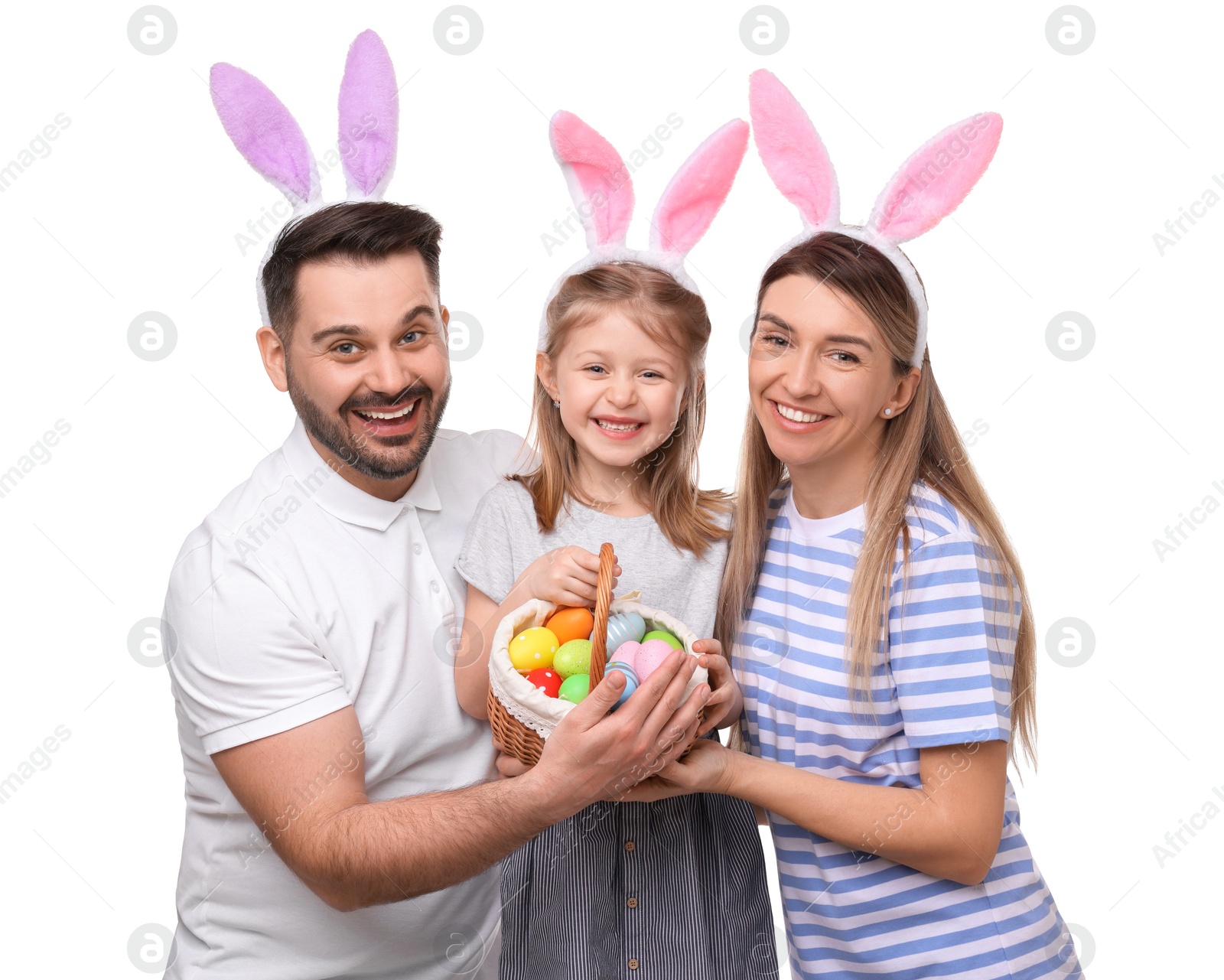 Photo of Easter celebration. Happy family with bunny ears and wicker basket full of painted eggs isolated on white