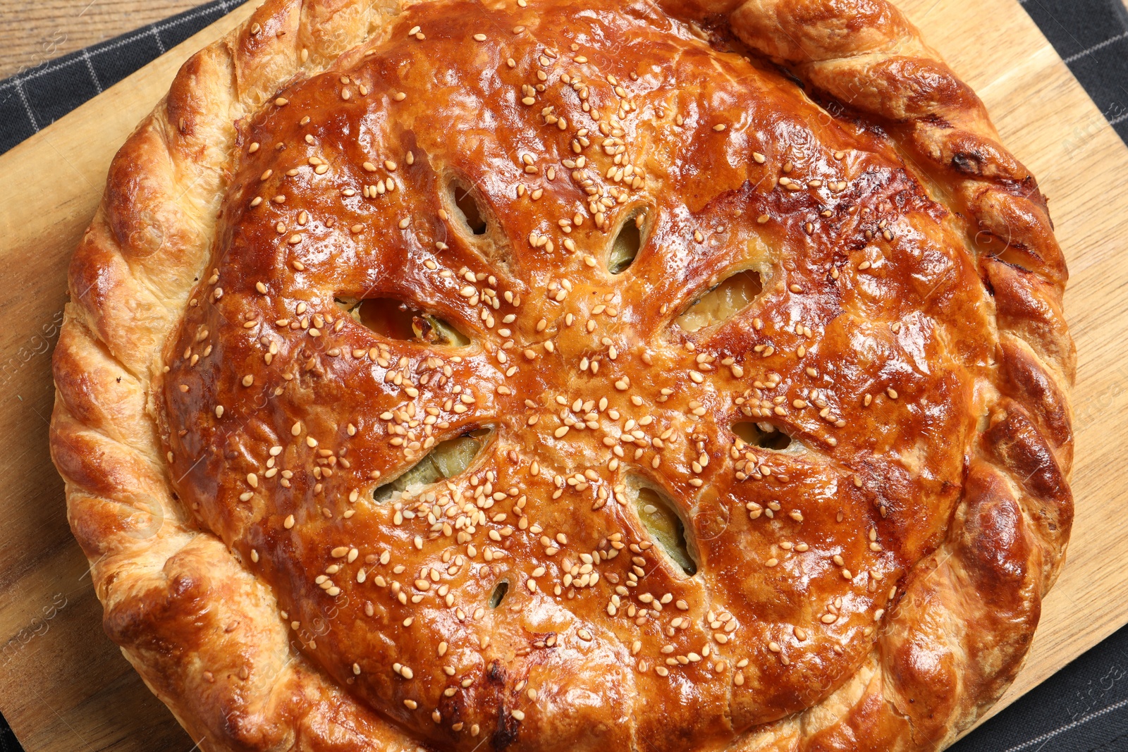 Photo of Tasty homemade pie with filling on wooden table, top view