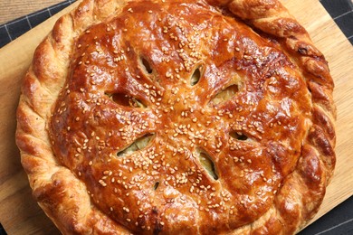 Photo of Tasty homemade pie with filling on wooden table, top view