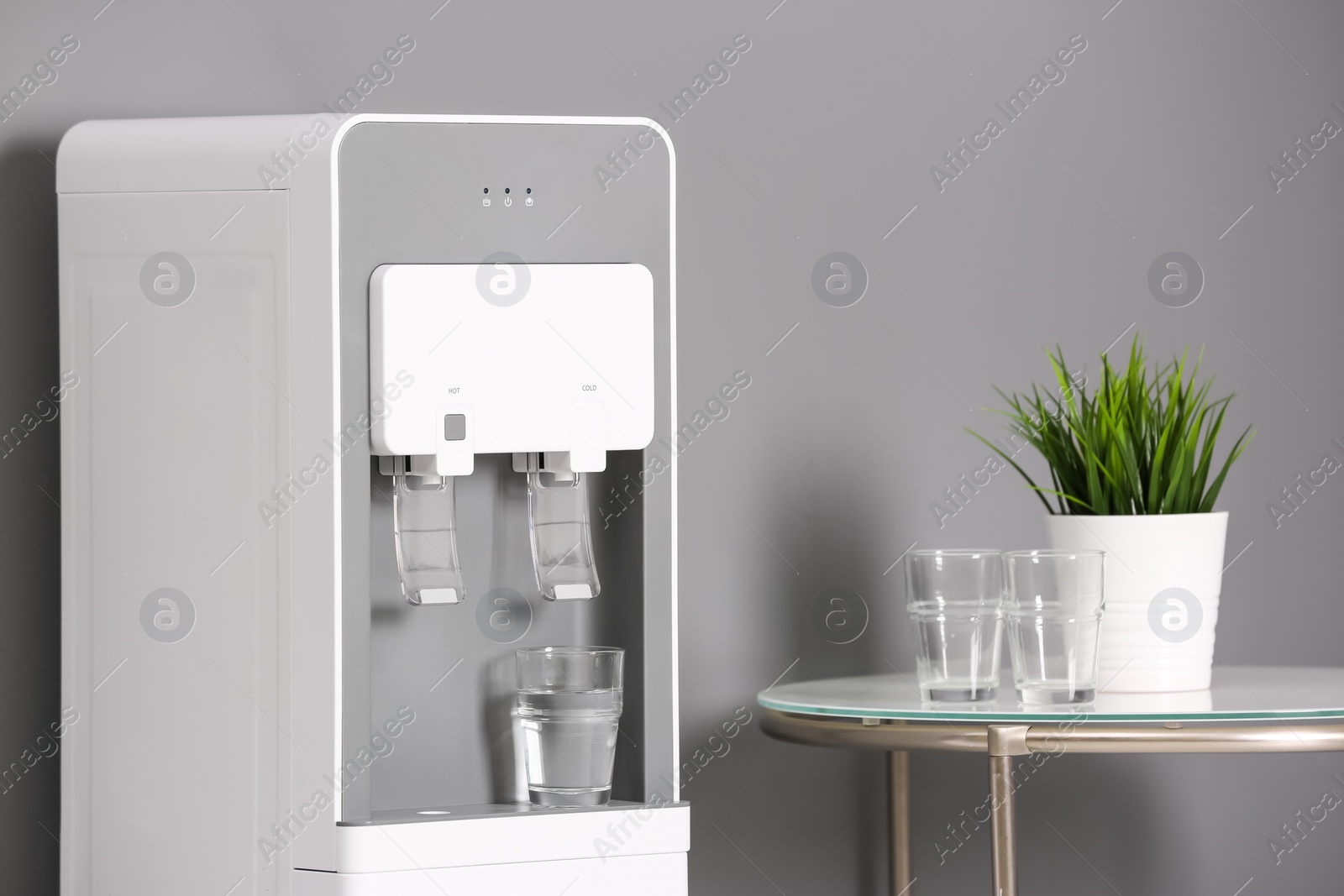 Photo of Modern water cooler in stylish office interior