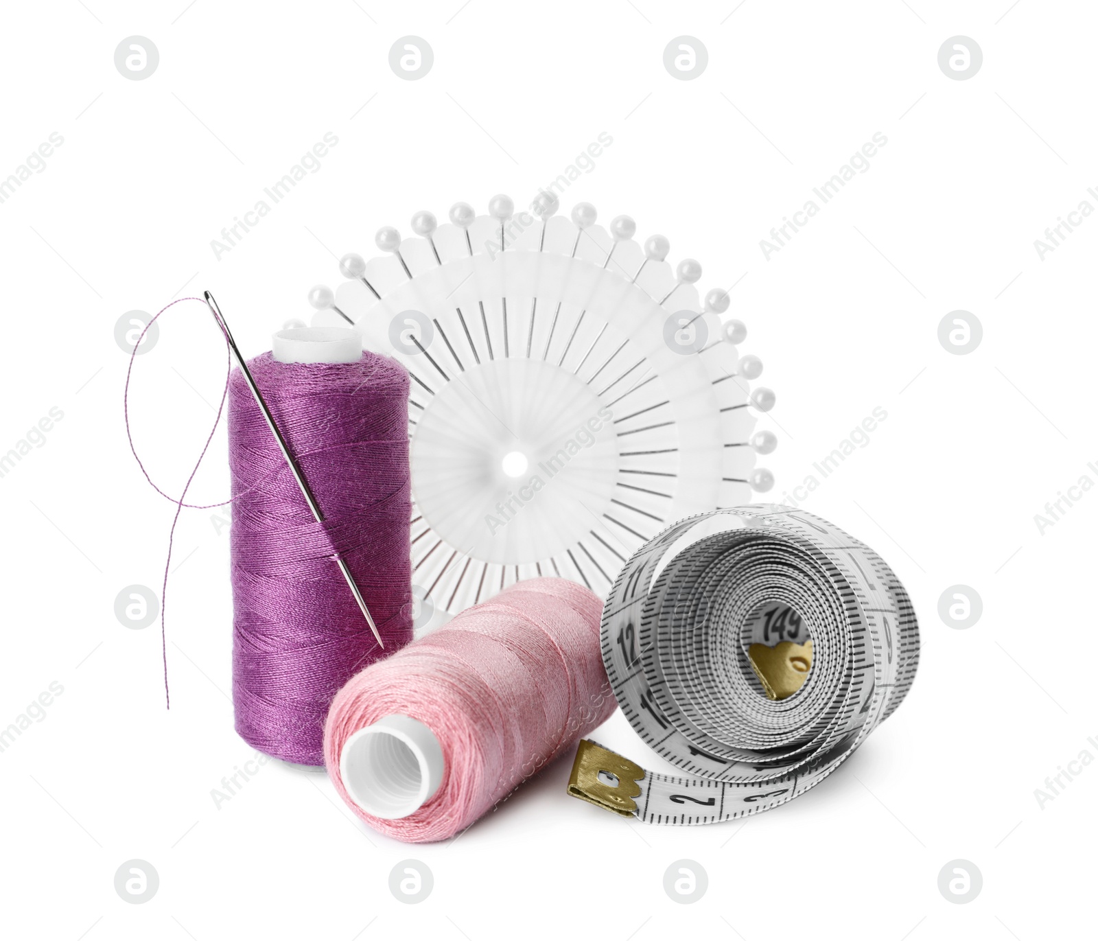 Photo of Spools of threads and sewing tools on white background