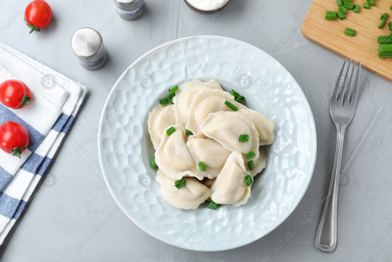 Photo of Flat lay composition with tasty dumplings served on grey table