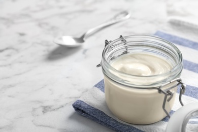 Photo of Jar with yummy yogurt on table