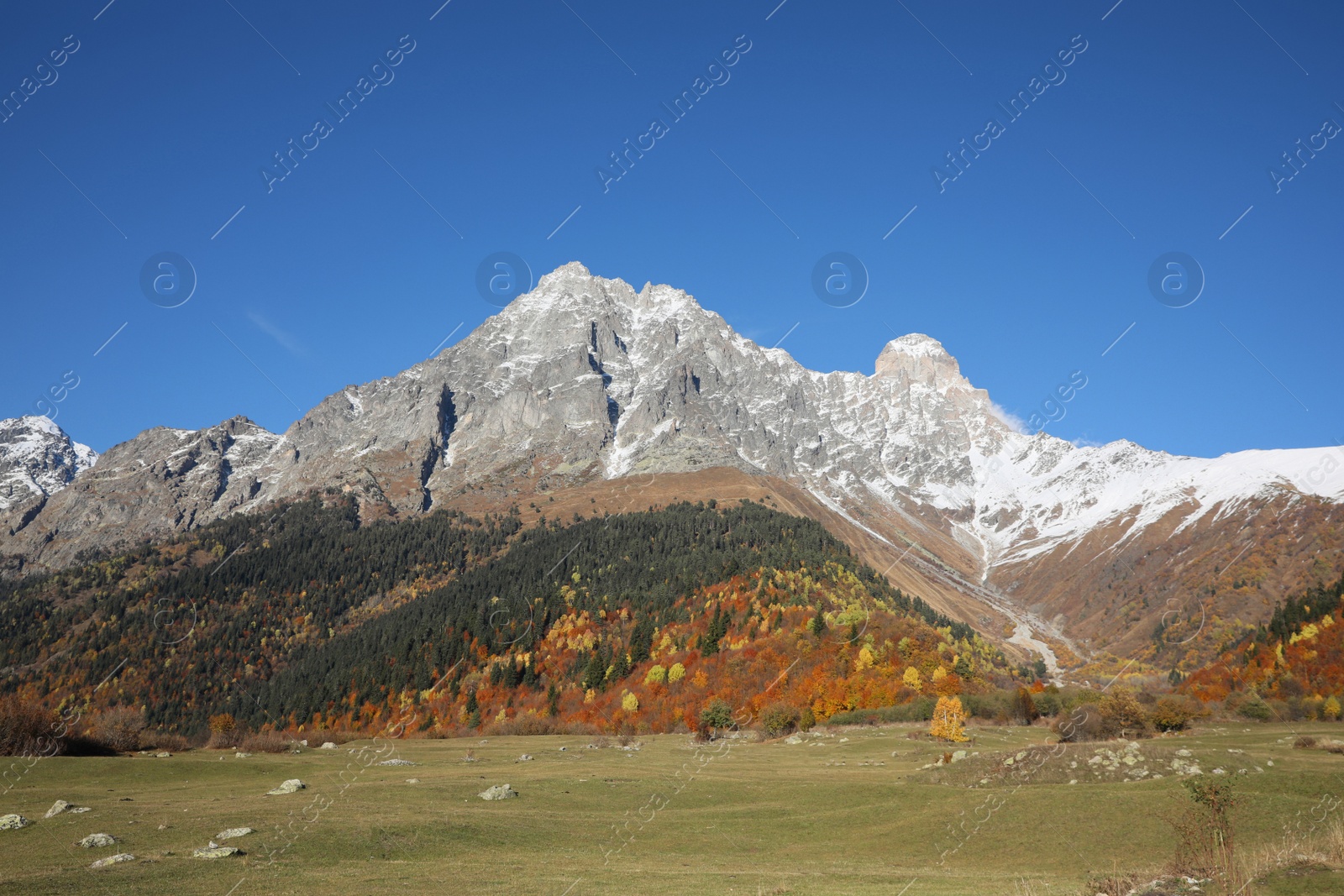 Photo of Picturesque view of beautiful high mountains under blue sky on sunny day