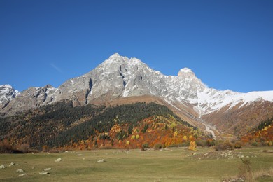 Picturesque view of beautiful high mountains under blue sky on sunny day