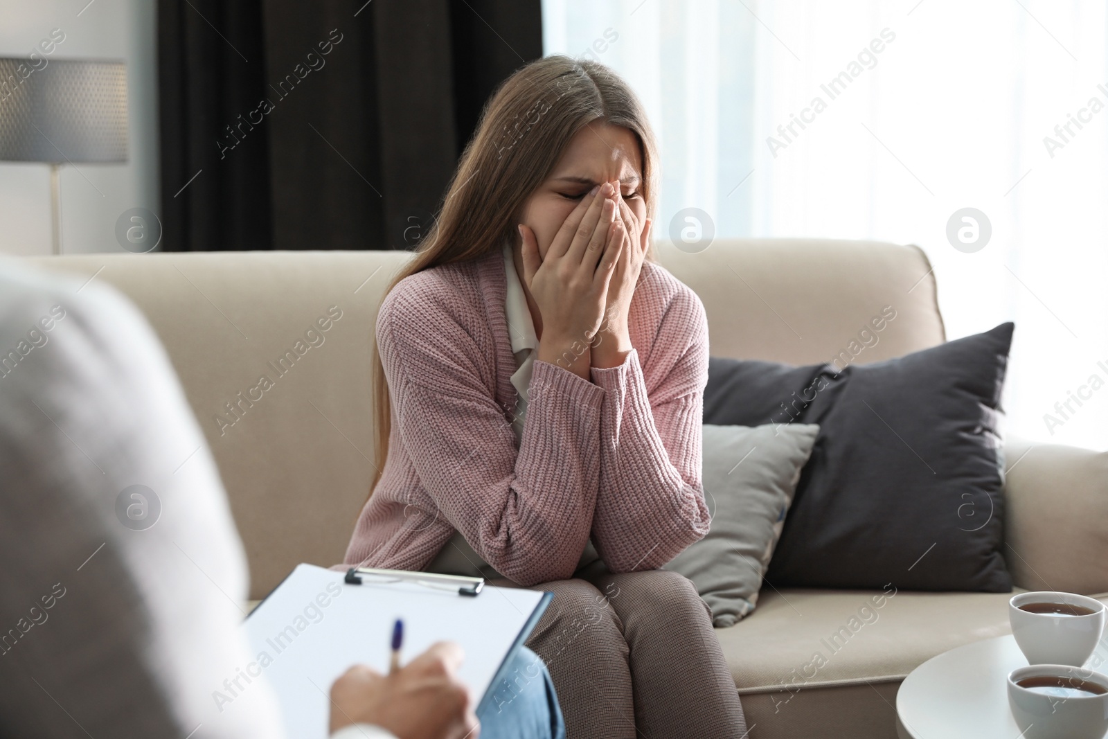 Photo of Professional psychotherapist working with patient in office