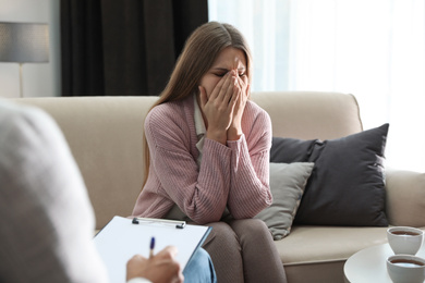 Photo of Professional psychotherapist working with patient in office