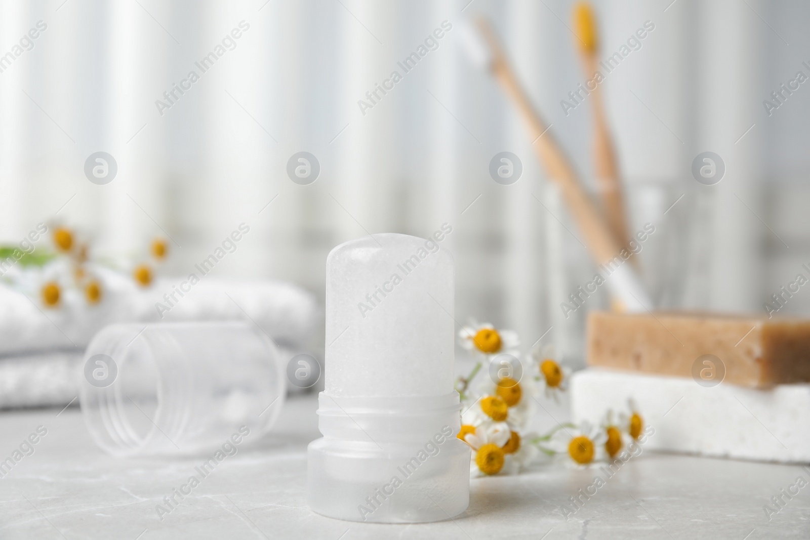 Photo of Natural crystal alum deodorant on light grey marble background