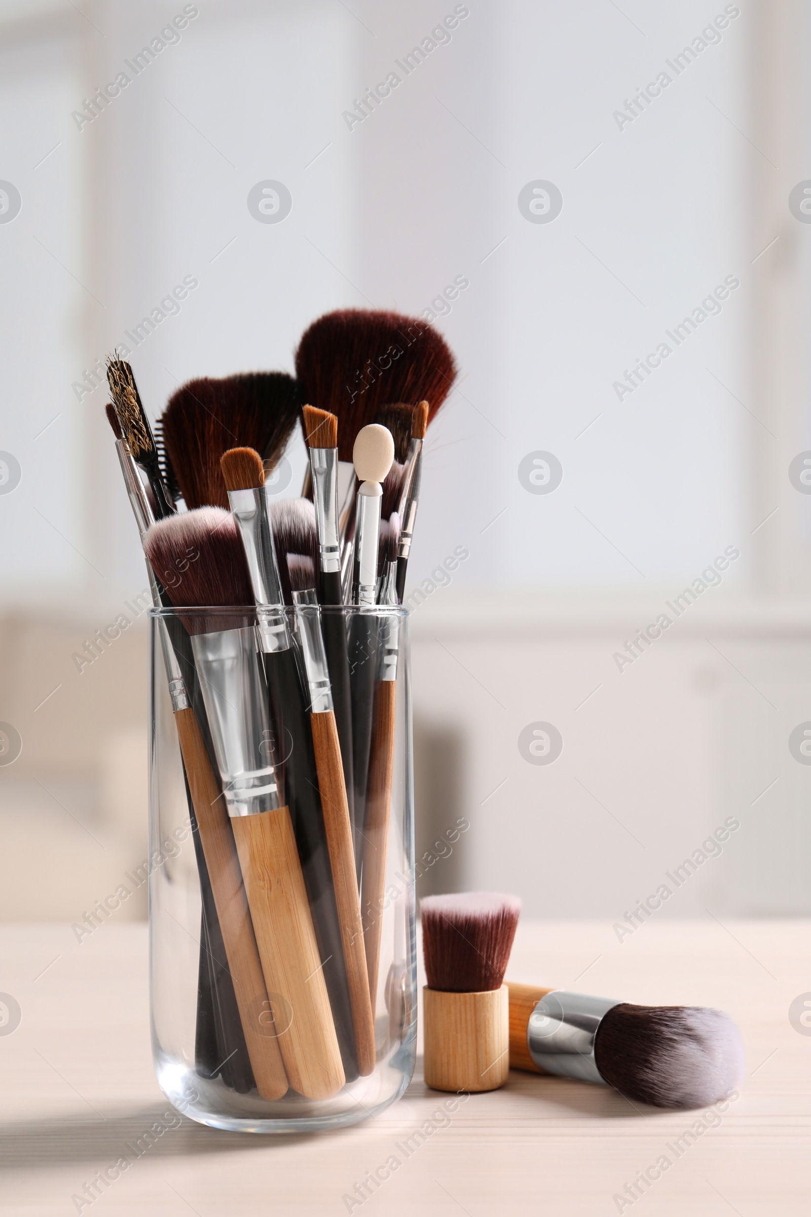 Photo of Set of professional brushes on wooden table indoors