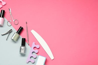 Nail polishes and set of pedicure tools on color background, flat lay. Space for text