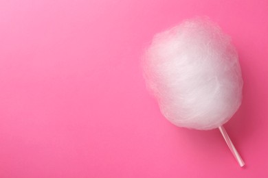 Photo of One sweet cotton candy on pink background, top view. Space for text