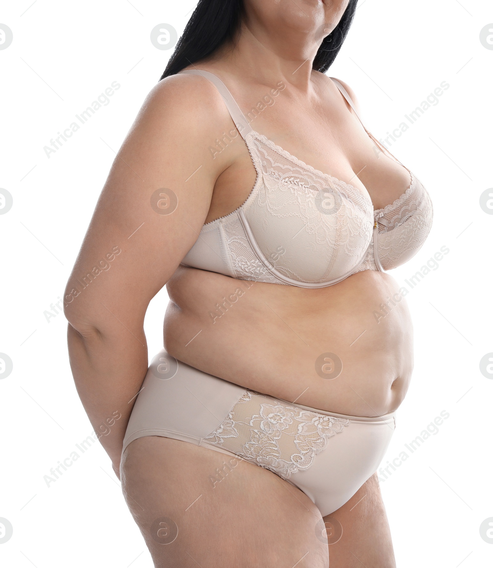 Photo of Overweight woman in beige underwear on white background, closeup. Plus-size model