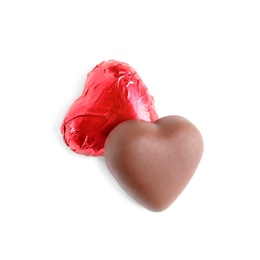 Photo of Heart shaped chocolate candies on white background, top view