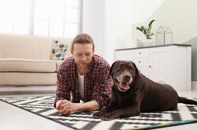 Photo of Adorable brown labrador retriever with owner at home