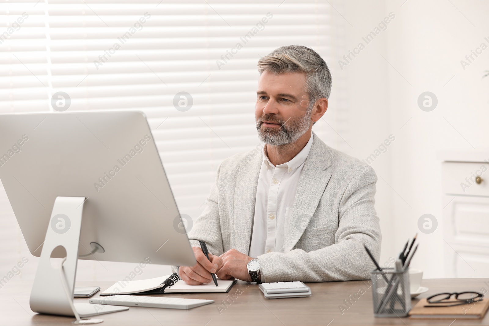 Photo of Professional accountant working at wooden desk in office