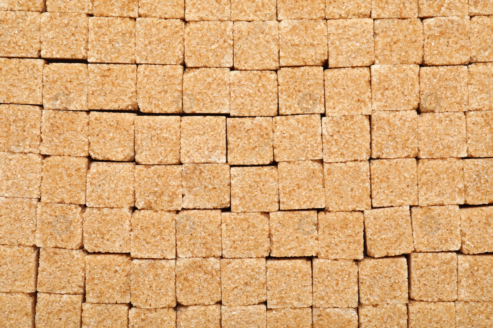 Photo of Brown sugar cubes as background, top view