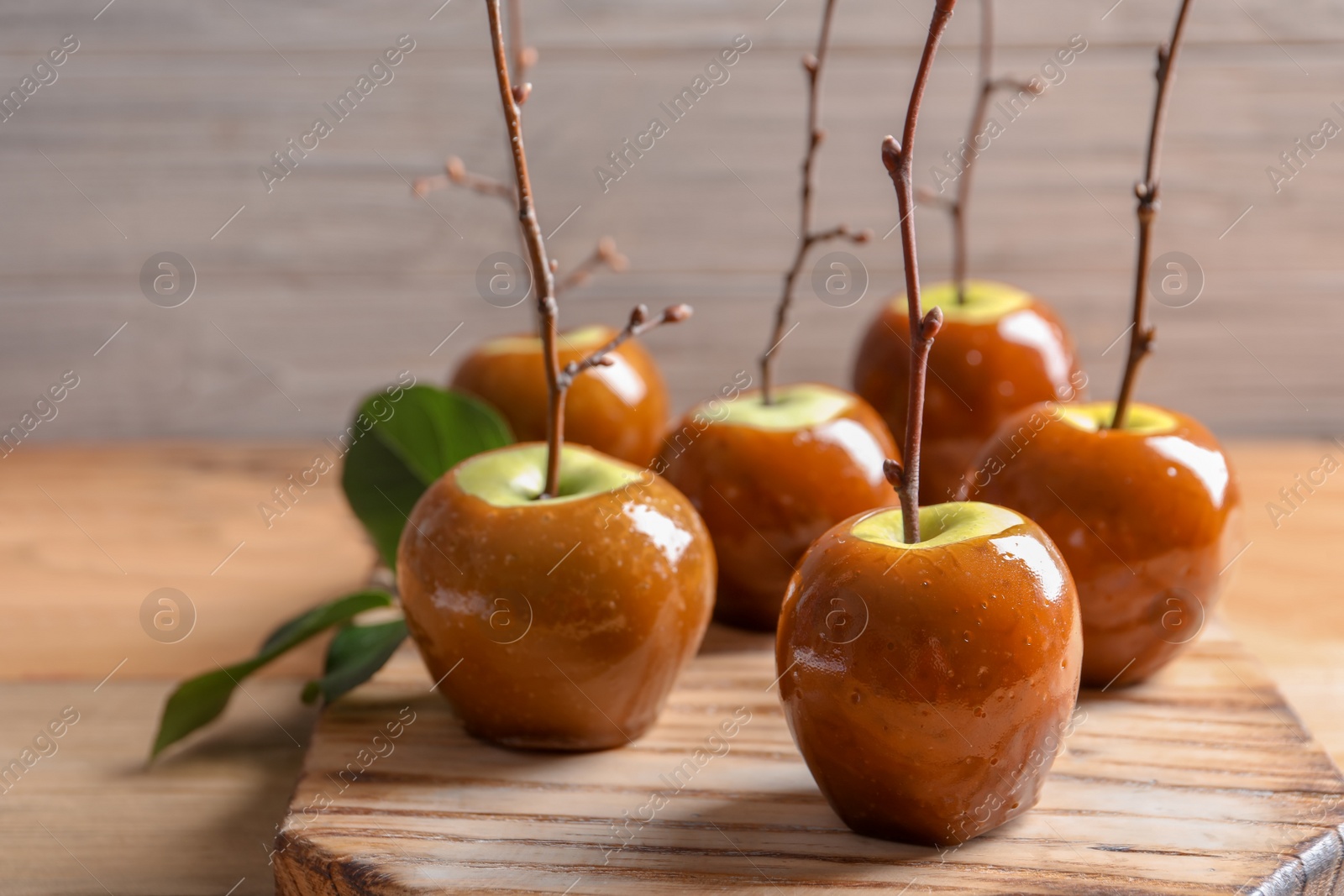 Photo of Delicious green caramel apples on table