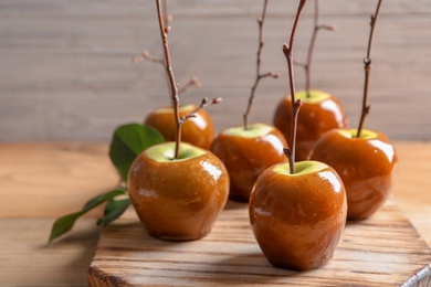 Delicious green caramel apples on table