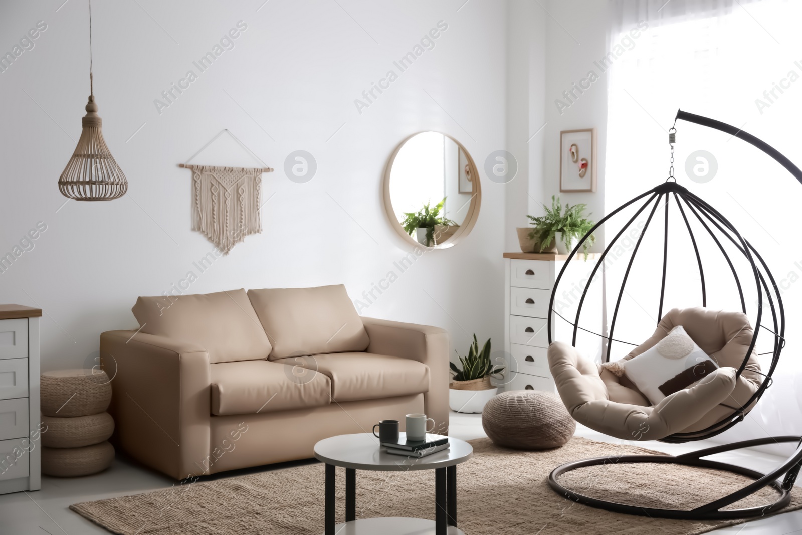 Photo of Stylish leather sofa and swing chair in modern living room interior