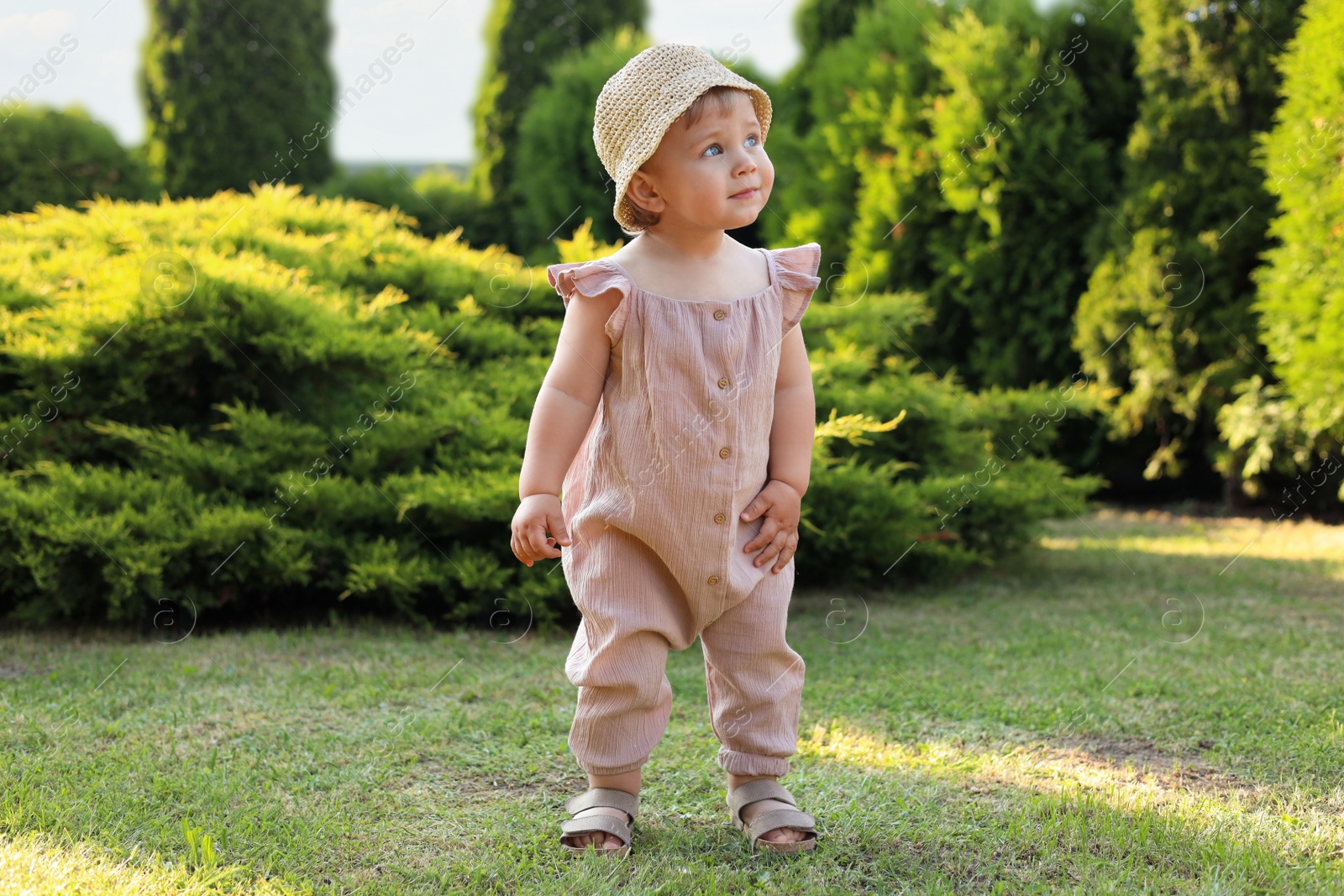 Photo of Cute little girl wearing stylish clothes outdoors on sunny day