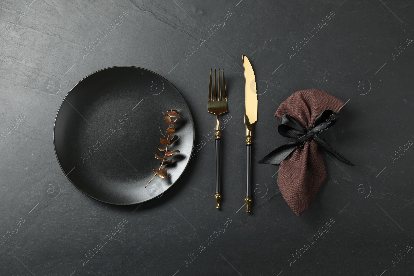 Photo of Stylish setting with elegant cutlery on grey textured table, flat lay