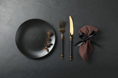 Photo of Stylish setting with elegant cutlery on grey textured table, flat lay