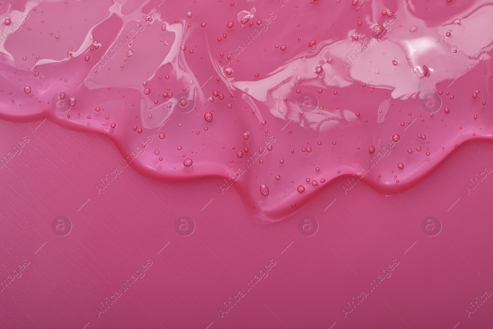 Photo of Pure transparent cosmetic gel on pink background, top view