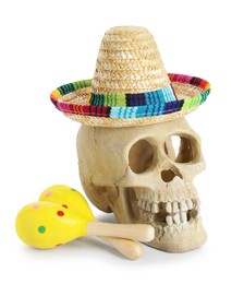 Photo of Human scull with Mexican sombrero hat and maracas isolated on white