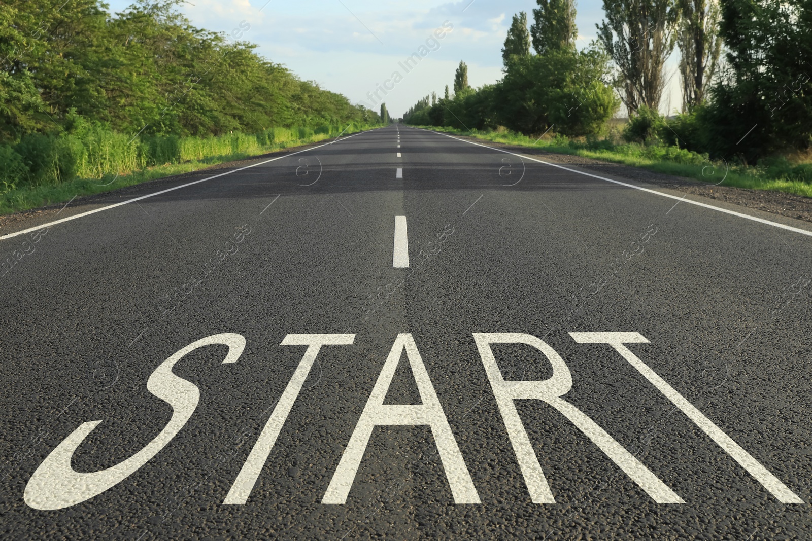 Image of New beginnings. Word Start on asphalt road outdoors