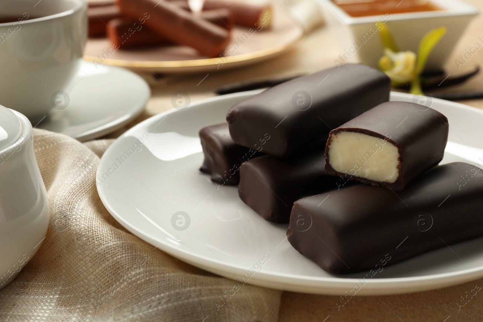 Photo of Glazed vanilla curd cheese bars served on table, closeup