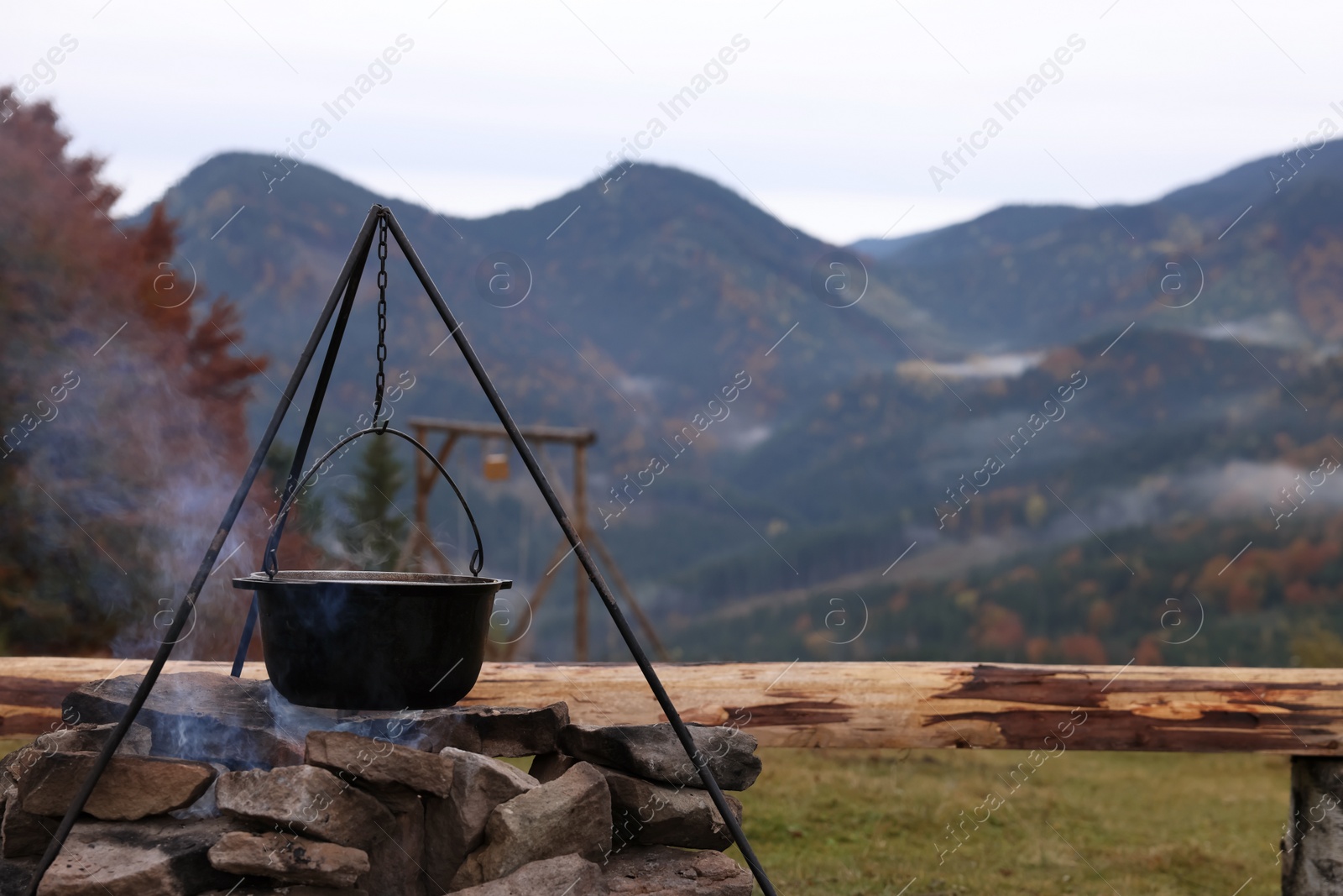 Photo of Cooking food on campfire in mountains. Camping season