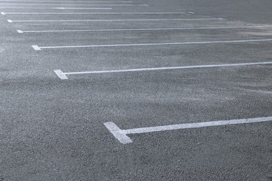 Photo of Car parking lot with white marking outdoors