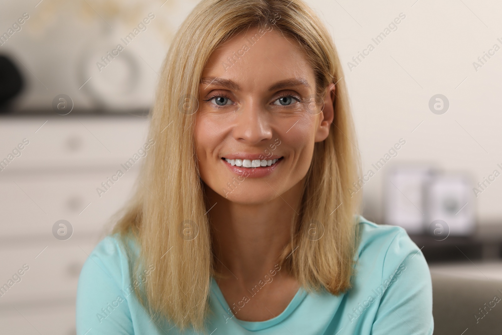 Photo of Portrait of beautiful woman with blonde hair. Attractive lady smiling and looking into camera