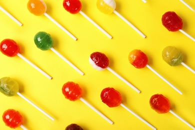 Flat lay composition with different tasty candies on color background