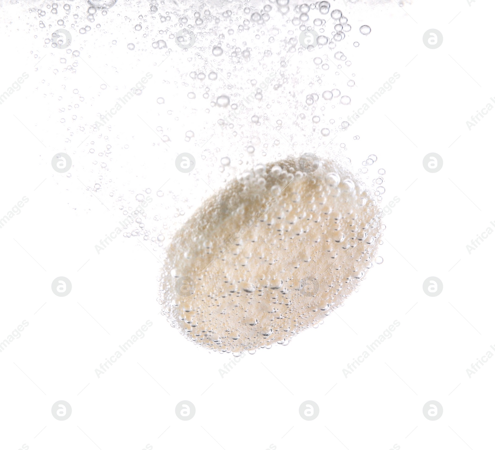 Photo of Effervescent pill dissolving in water on white background, closeup