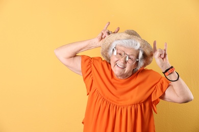 Photo of Portrait of cool grandmother on color background, space for text