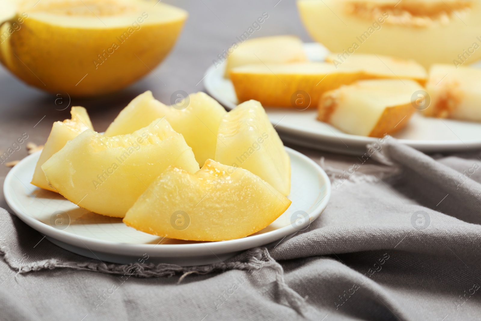 Photo of Plate with cut sweet melon on table