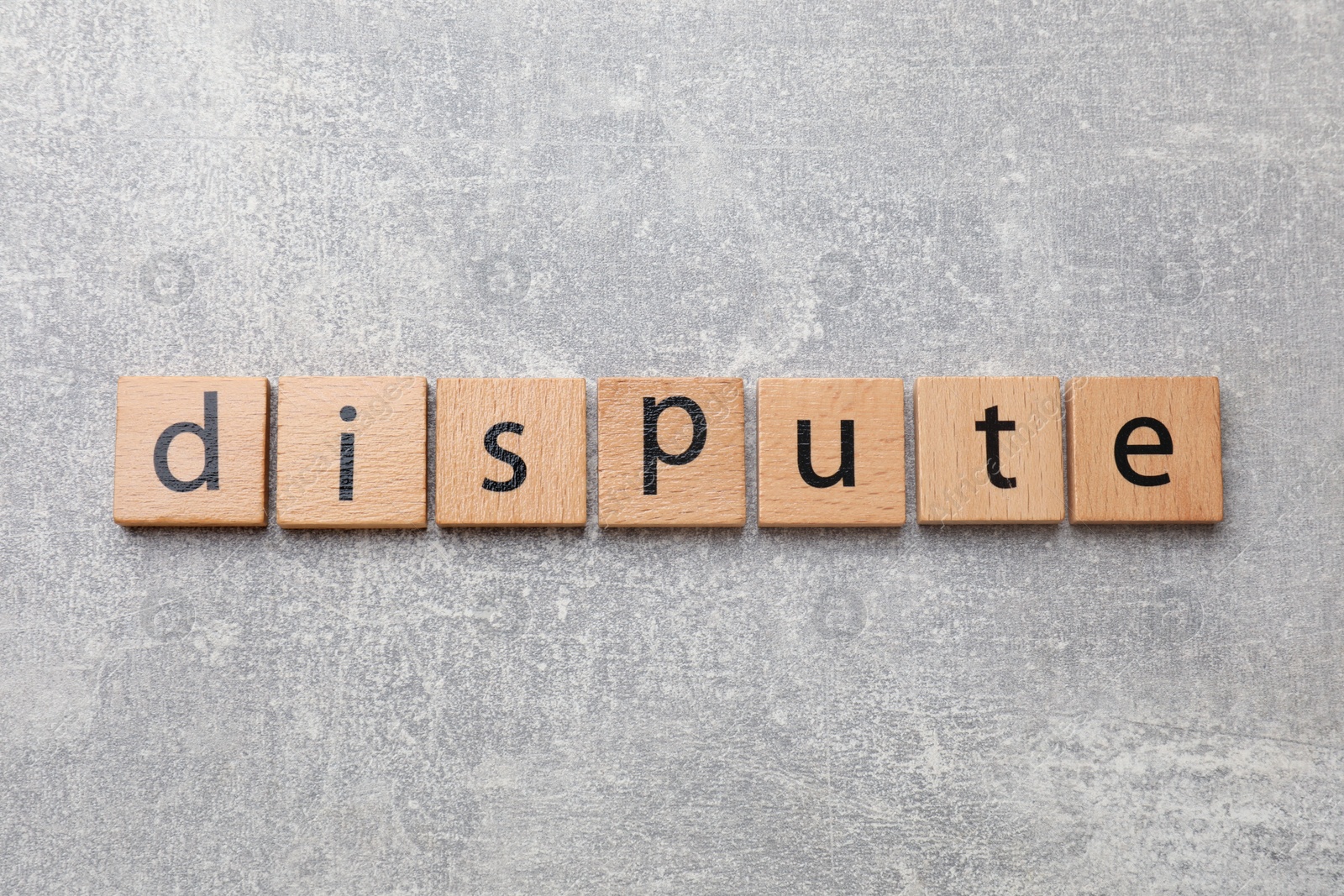 Photo of Squares with word Dispute on grey table, top view