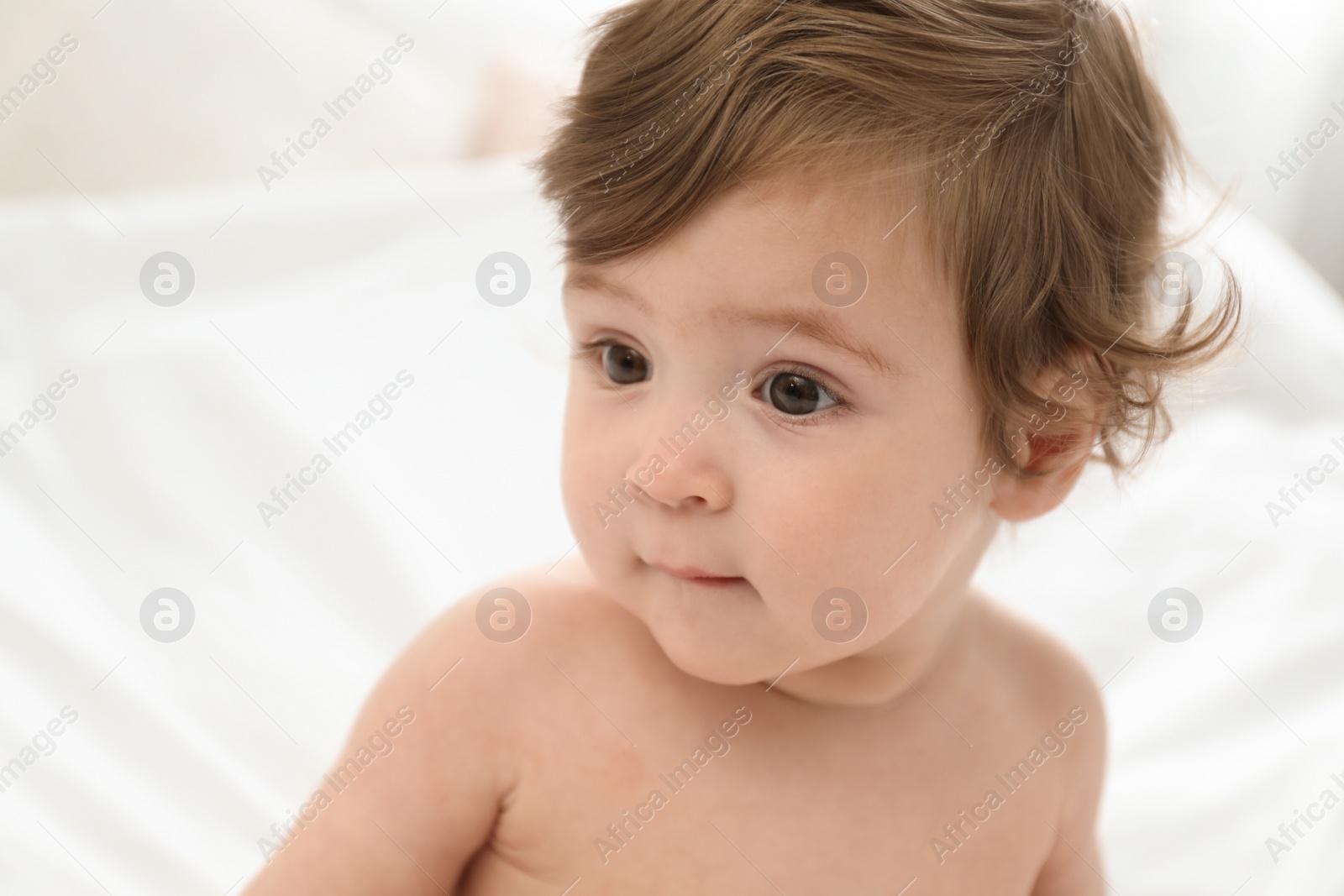 Photo of Adorable little baby on bed. Cute child