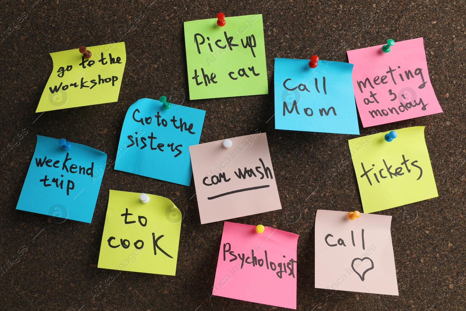 Photo of Colorful reminder notes pinned to cork board