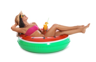 Beautiful young woman with inflatable ring and glass of cocktail on white background