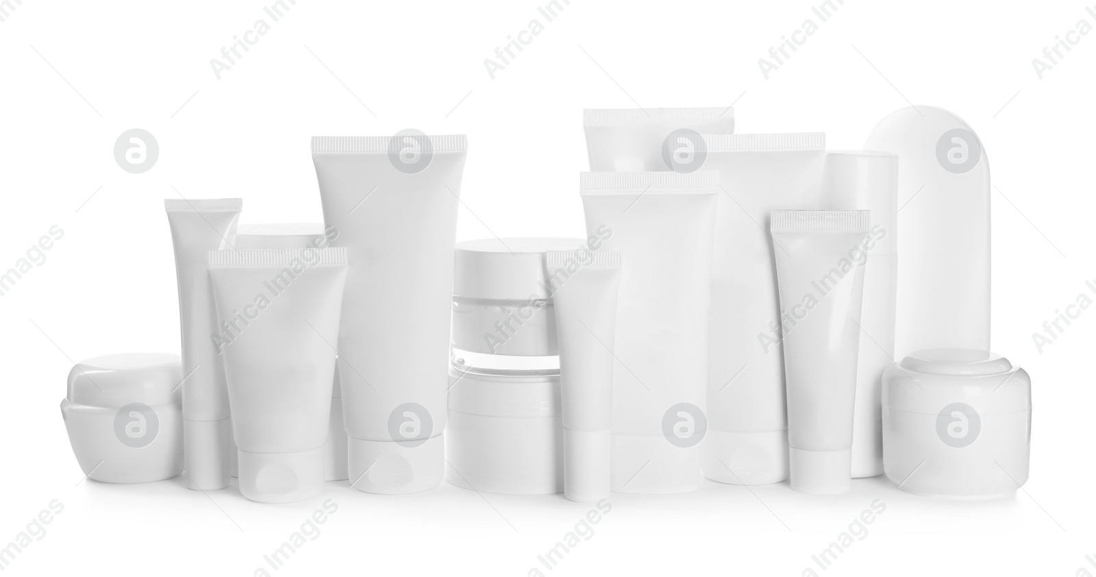 Photo of Blank tubes and jars of cosmetic products on white background