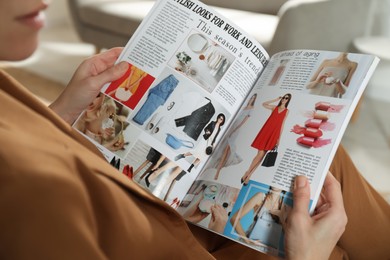 Photo of Woman reading fashion magazine at home, closeup