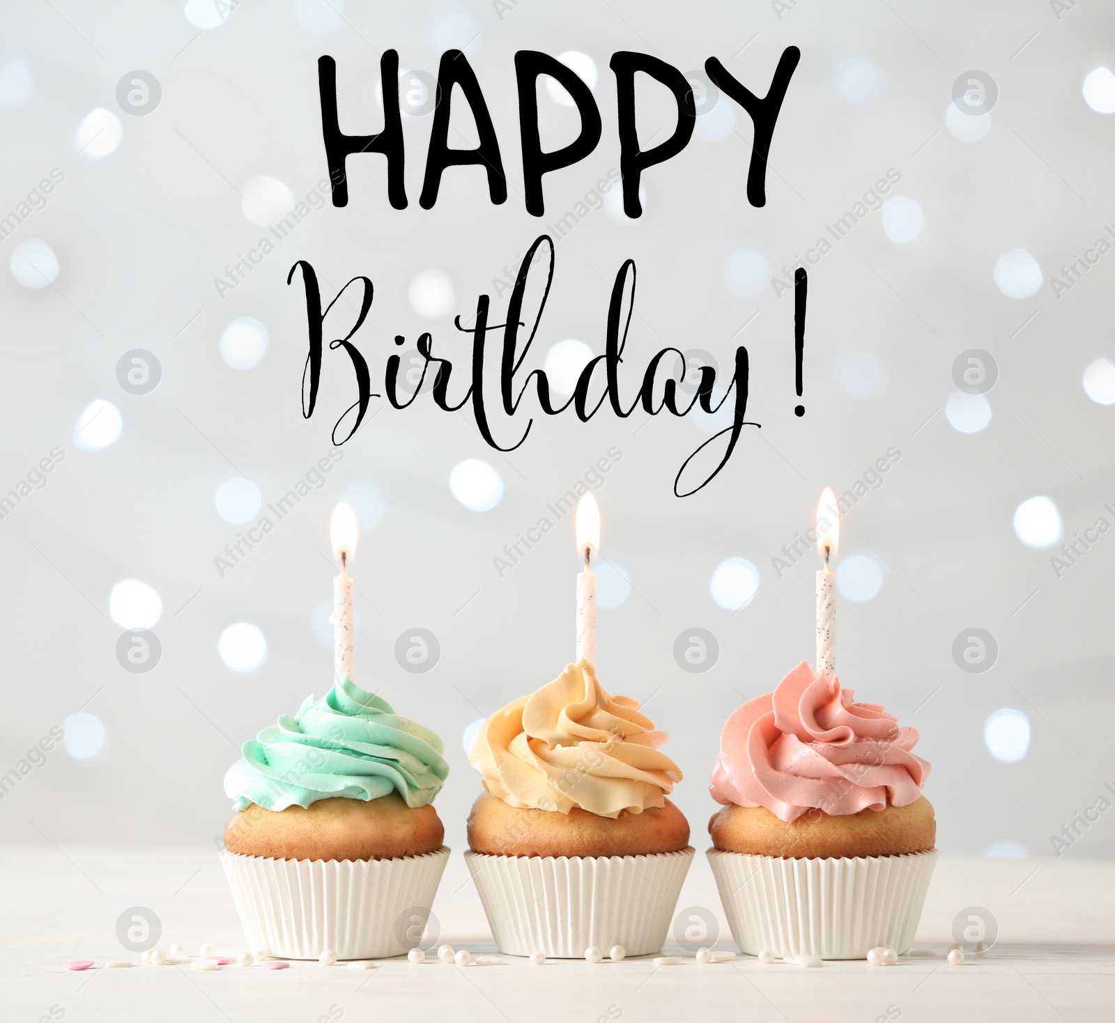 Image of Happy Birthday! Delicious cupcakes with burning candles on white table